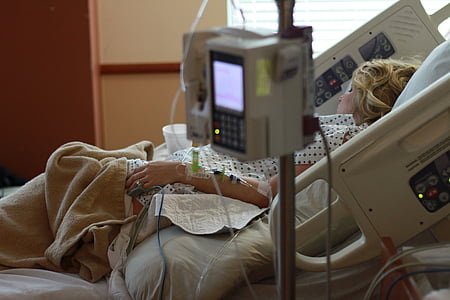 woman lying on hospital bed inside hospital thumbnail