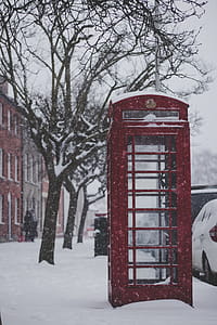 Red Telephone Booth on the Sidewalk With Snow thumbnail