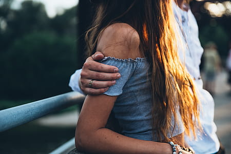 A young caucasian couple at sunset on a bridge thumbnail