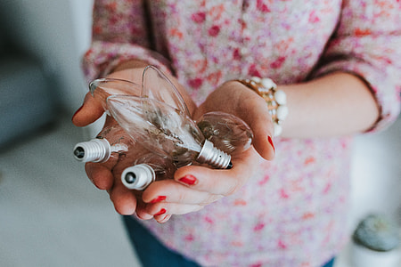 Woman in pink holding miscellaneous items thumbnail