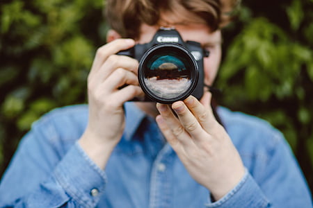 person using Canon DSLR camera thumbnail