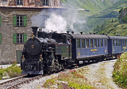 black and blue train near gray concrete house thumbnail