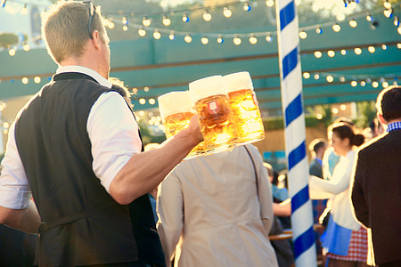 man holding beer mugs filled with beers thumbnail
