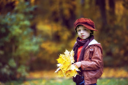 boy holding yellow leaves thumbnail