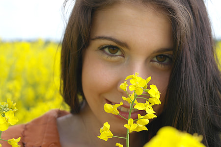 closeup photography of woman behind yellow flowers thumbnail
