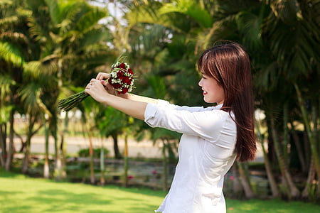 woman holding red roses bouquet thumbnail