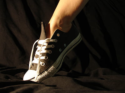 person wearing black low-top sneaker thumbnail