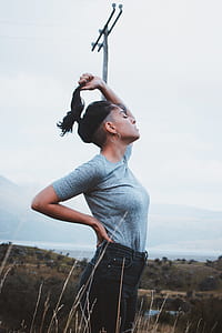 woman wearing gray shirt near light post thumbnail