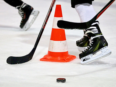 person wearing pairs of black ice hockey skates thumbnail