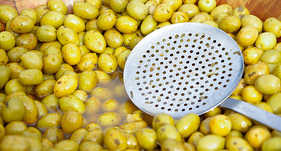 gray steel strainer on green fruits thumbnail