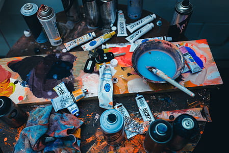paint tubes and spray can on table thumbnail