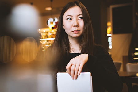 Young college student in a cafe with tablet in hand thumbnail