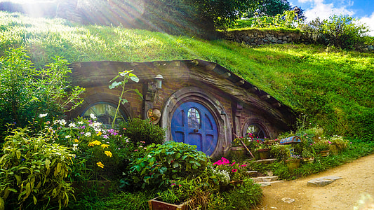 brown wooden underground house under green grass thumbnail