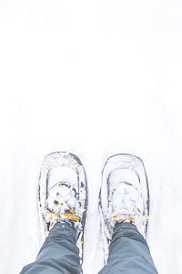 person wearing snow shoes standing on snow thumbnail