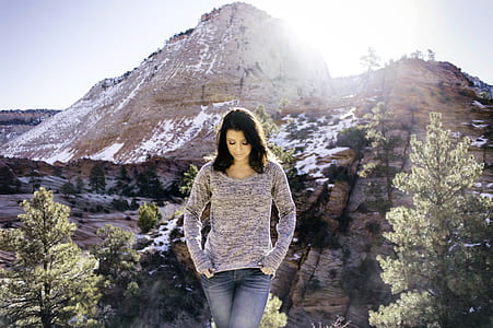 woman walking near mountain at daytime thumbnail