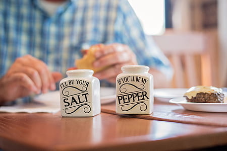 selective focus photography of pepper and salt shaker on brown wooden surface thumbnail