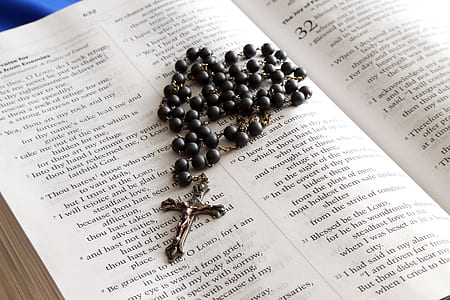 black and silver-colored rosary on bible thumbnail