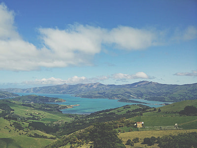 landscape photography of body of water surrounded by mountains thumbnail