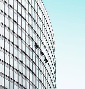 glass high-rise building under clear blue sky during daytime thumbnail