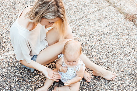 woman sitting beside toddler's on road thumbnail
