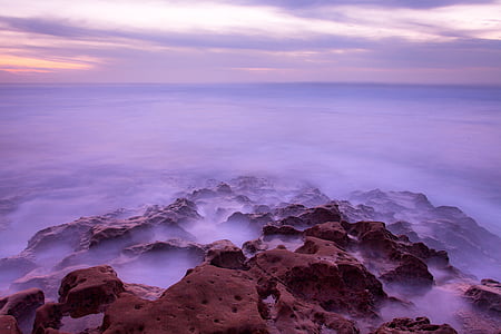 fogs on rocks under cloudy sky at daytime thumbnail
