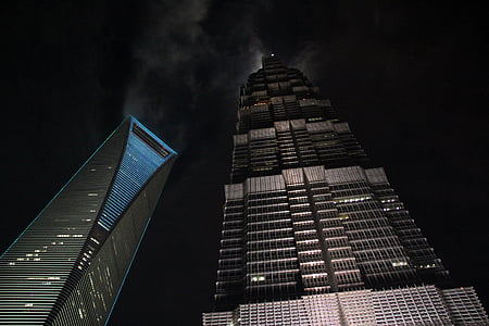 worm's eyeview photography of gray building during nighttime thumbnail