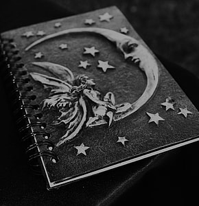 black and gray notebook with embossed crescent moon and fairy design thumbnail