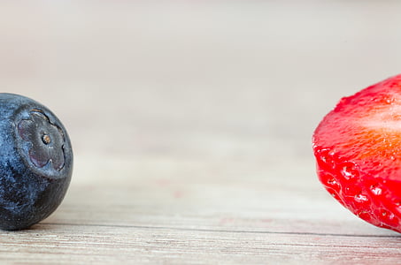 blueberry beside sliced strawberry thumbnail