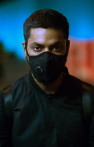 tilt-shift photography of person wearing face mask thumbnail