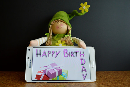 white Samsung Galaxy Android smartphone beside doll thumbnail
