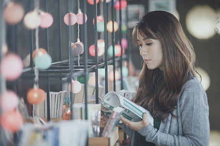 woman standing holding book thumbnail