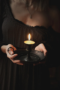woman holding black oil lantern thumbnail