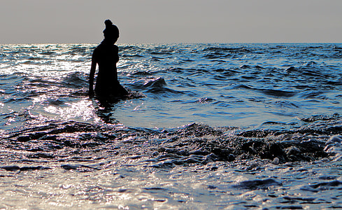 silhouette photography of woman in body of water thumbnail