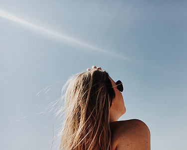 woman wearing gray framed aviators during day time thumbnail