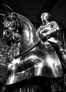 grayscale photography of person in armor riding on horse statue thumbnail