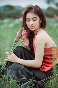 Selective Focus Photography Of Woman In Orange Top thumbnail
