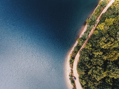 aerial view of road beside body of watetr thumbnail