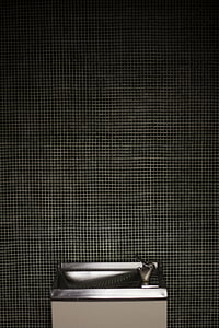 gray drinking fountain behind gray wall thumbnail