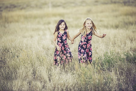 shallow focus photography of two girls thumbnail