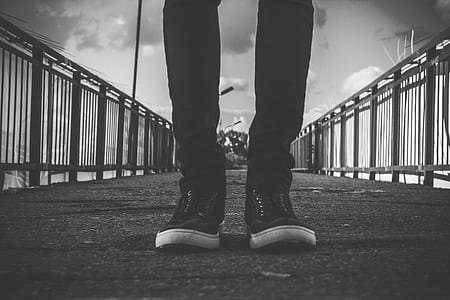 Person in Black Skinny Jeans Standing at the Center of Road thumbnail