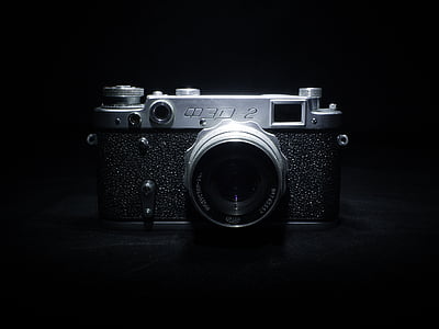 gray and black camera on black surface thumbnail