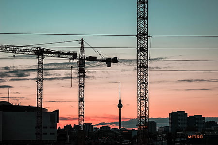 black metal cranes during golden hour thumbnail