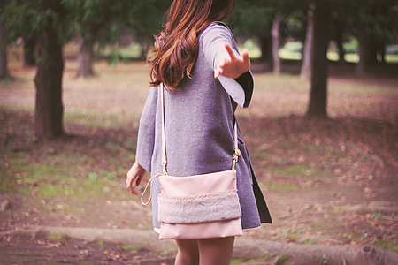 woman wearing gray coat and sling bag thumbnail
