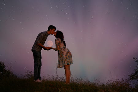 couple kissing with moon and stars in the background thumbnail