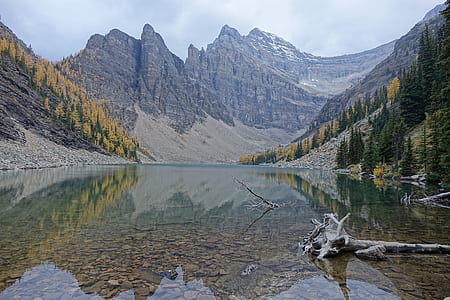 body of water within mountain range during daytime thumbnail