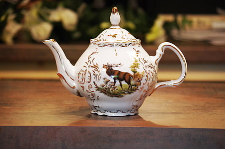 ceramic teapot on wooden surface selective focus photography thumbnail