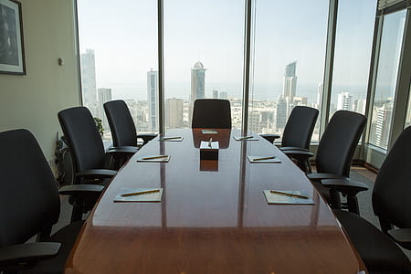 brown wooden conference table inside room thumbnail
