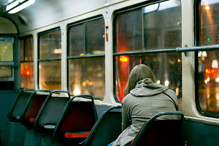 person sitting beside vehicle window thumbnail