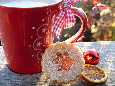 red ceramic mug beside cracker thumbnail