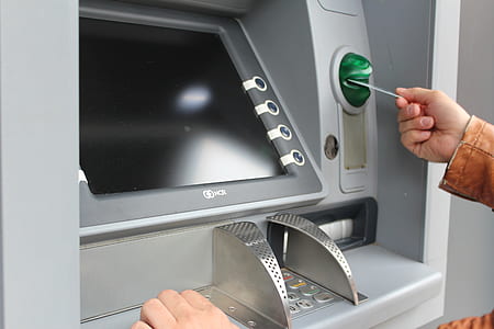 person holding card on ATM thumbnail